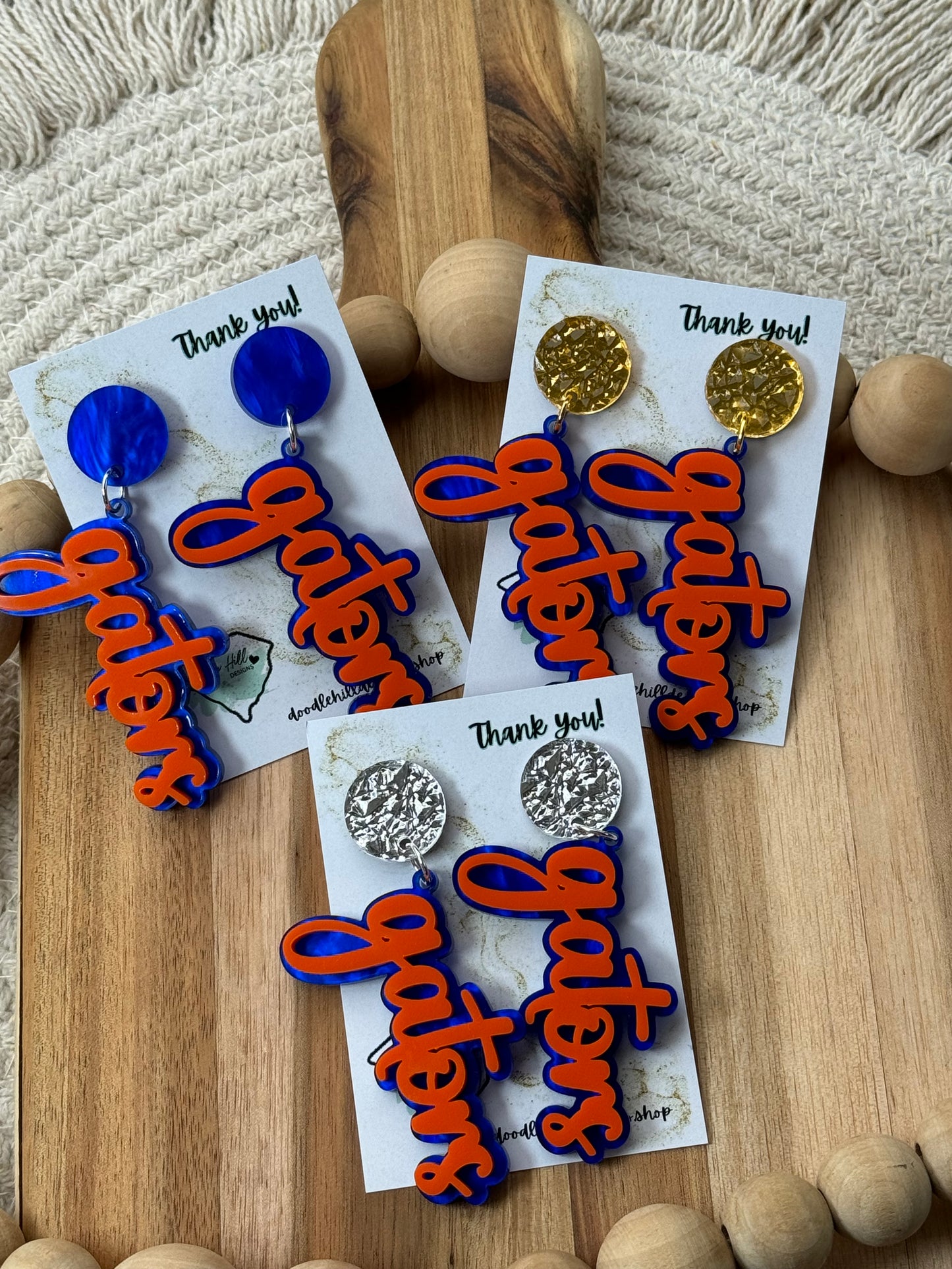 Game day spirit earrings, GATORS, earrings are two layers of acrylic blue and orange with different gold post