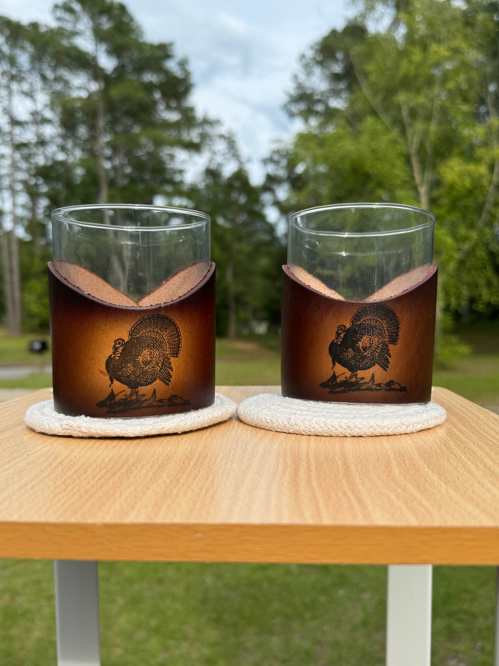 12 oz rocks glass with leather wrap. Wrap has turkey engraved on front of leather wrap