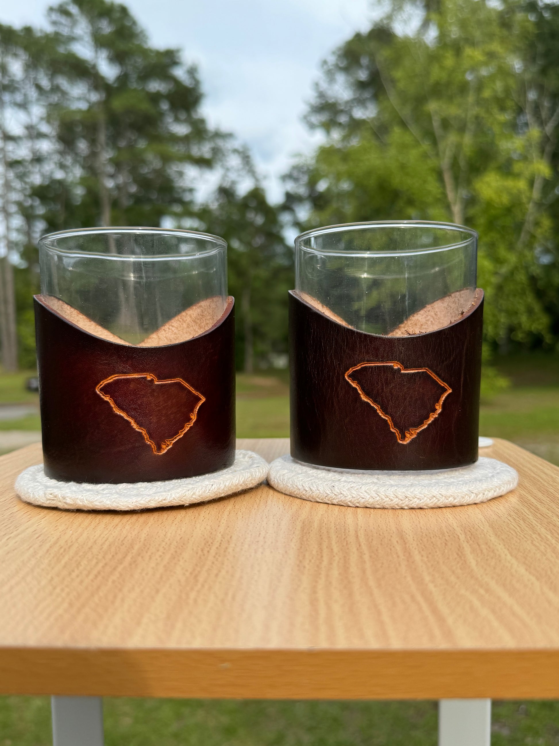 12 oz rocks glass with leather wrap. Wrap has outline with the state of South Carolina engraved on front of leather wrap