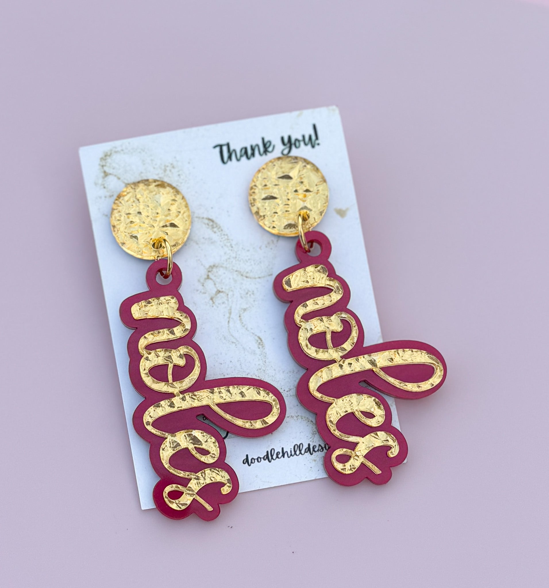 Game day spirit earrings, NOLES earrings are two layers of acrylic  garnet pearlize shimmer and gold textures with different  gold post 