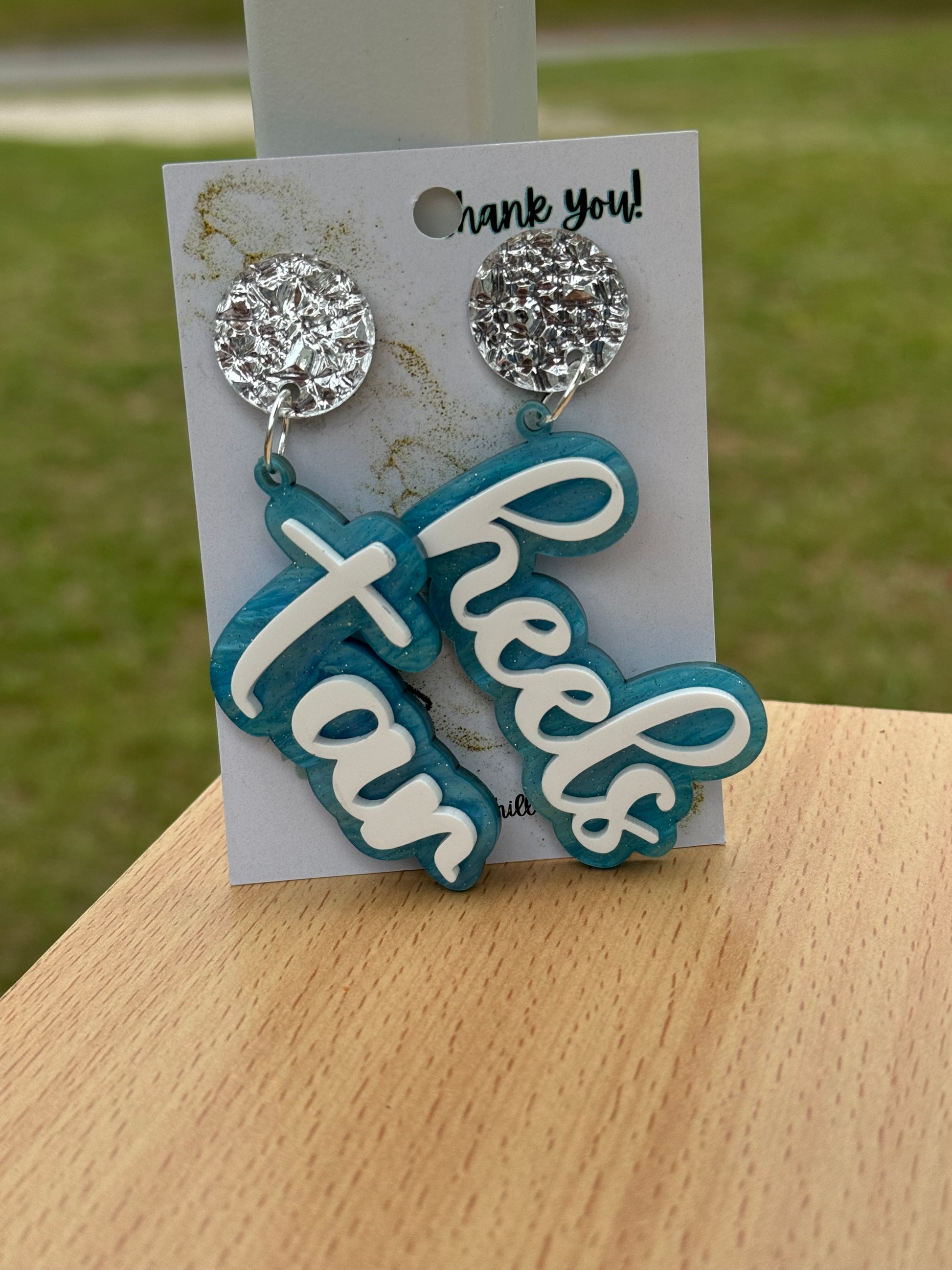 Game day spirit earrings, TAR HEELS earrings are two layers of acrylic  light blue pearlize shimmer and white words acrylic  with silverpost 