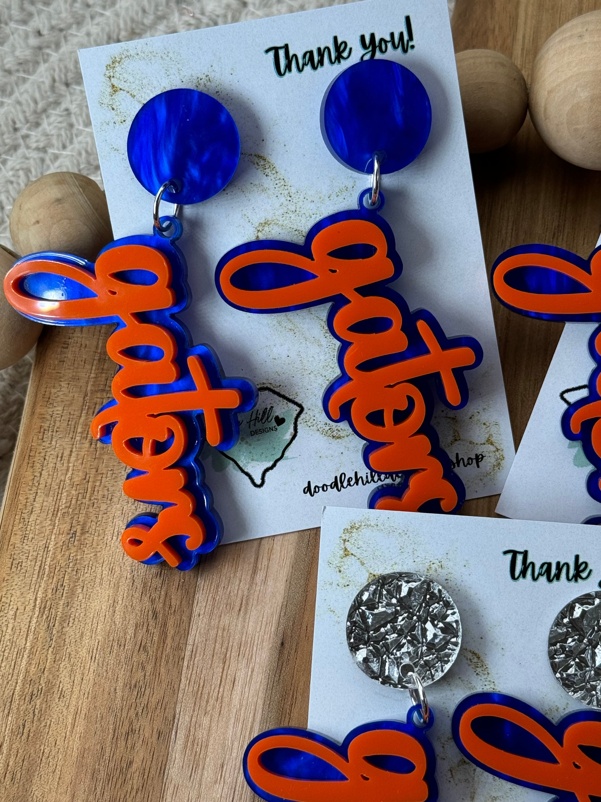 Game day spirit earrings, GATORS, earrings are two layers of acrylic blue and orange with different  blue post 