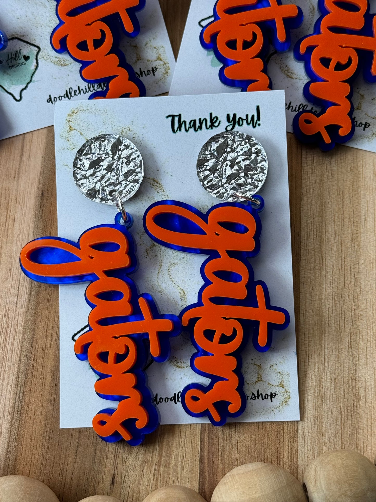Game day spirit earrings, GATORS, earrings are two layers of acrylic blue and orange with different  silver post 