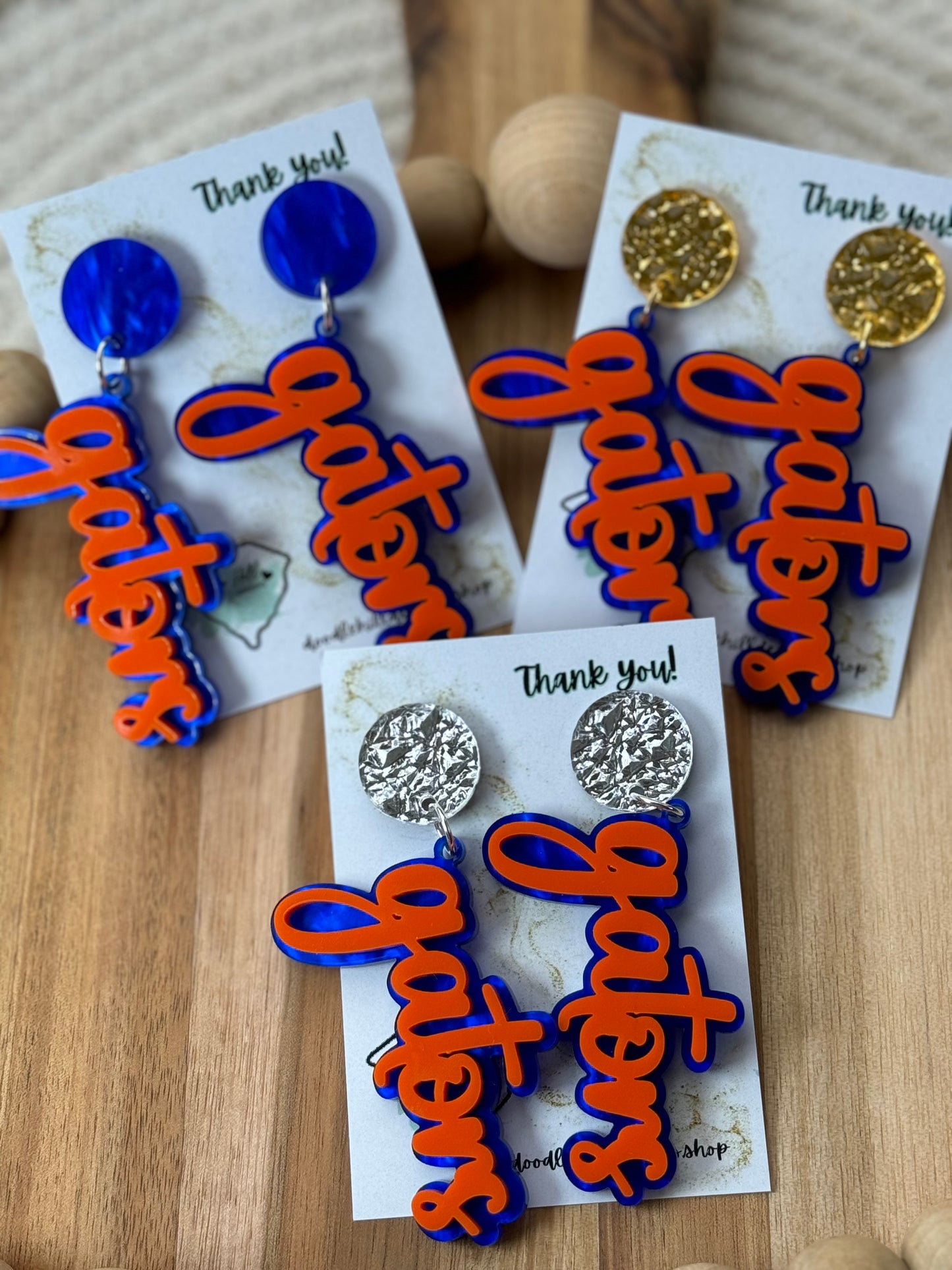 Game day spirit earrings, GATORS, earrings are two layers of acrylic blue and orange with different post silver, gold and blue