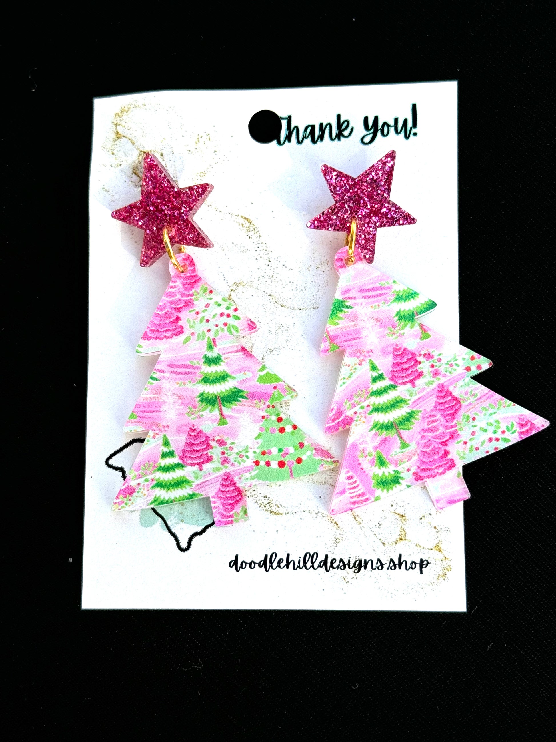 clear pastel pink and green christmas tree print with christmas tree shaped.Post are pink glitter stars 