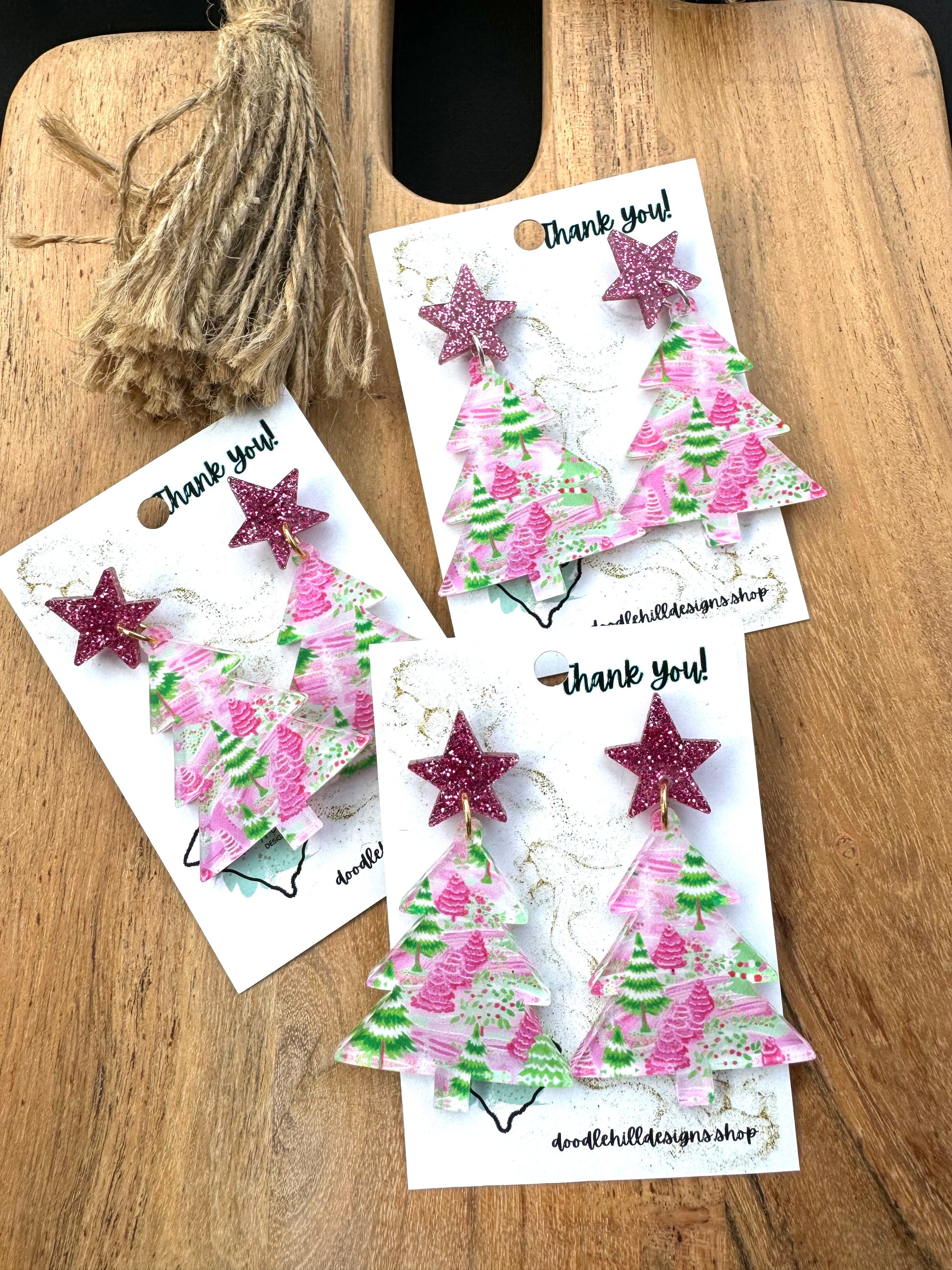 clear pastel pink and green christmas tree print with christmas tree shaped.Post are pink glitter stars 