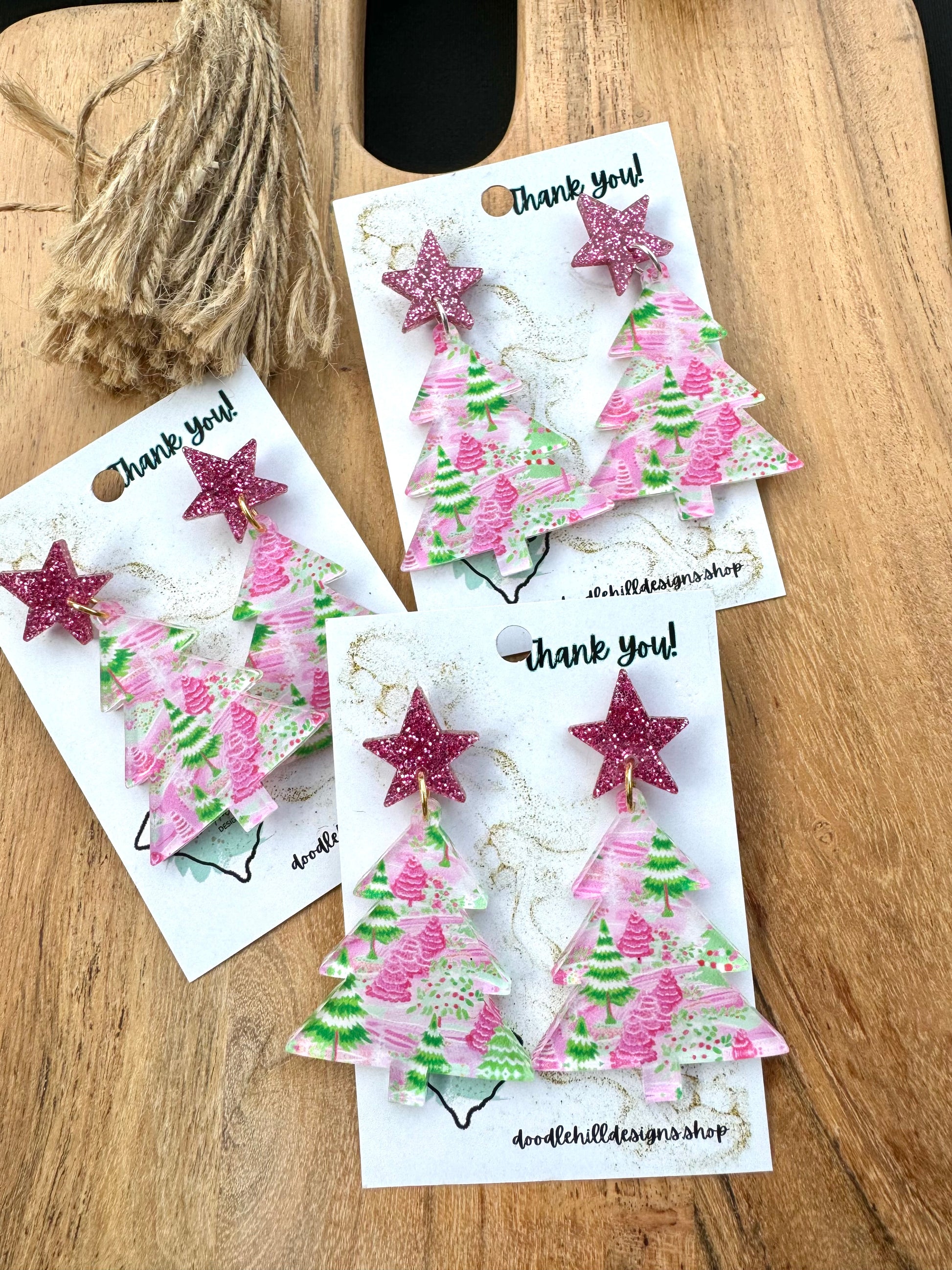 clear pastel pink and green christmas tree print with christmas tree shaped.Post are pink glitter stars 