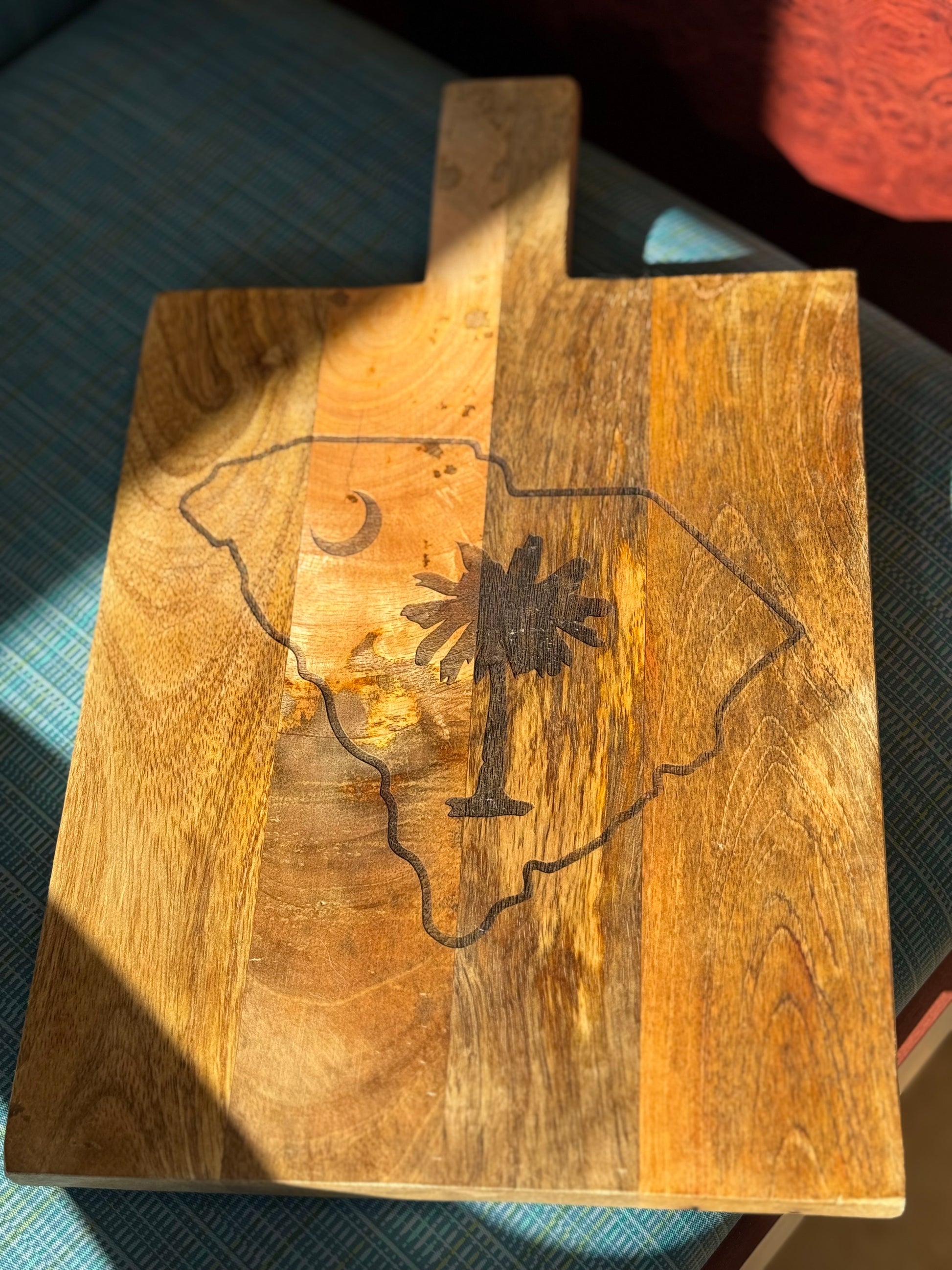 Personalized decorative cutting board with the state of south carolina with palmetto tree inside state