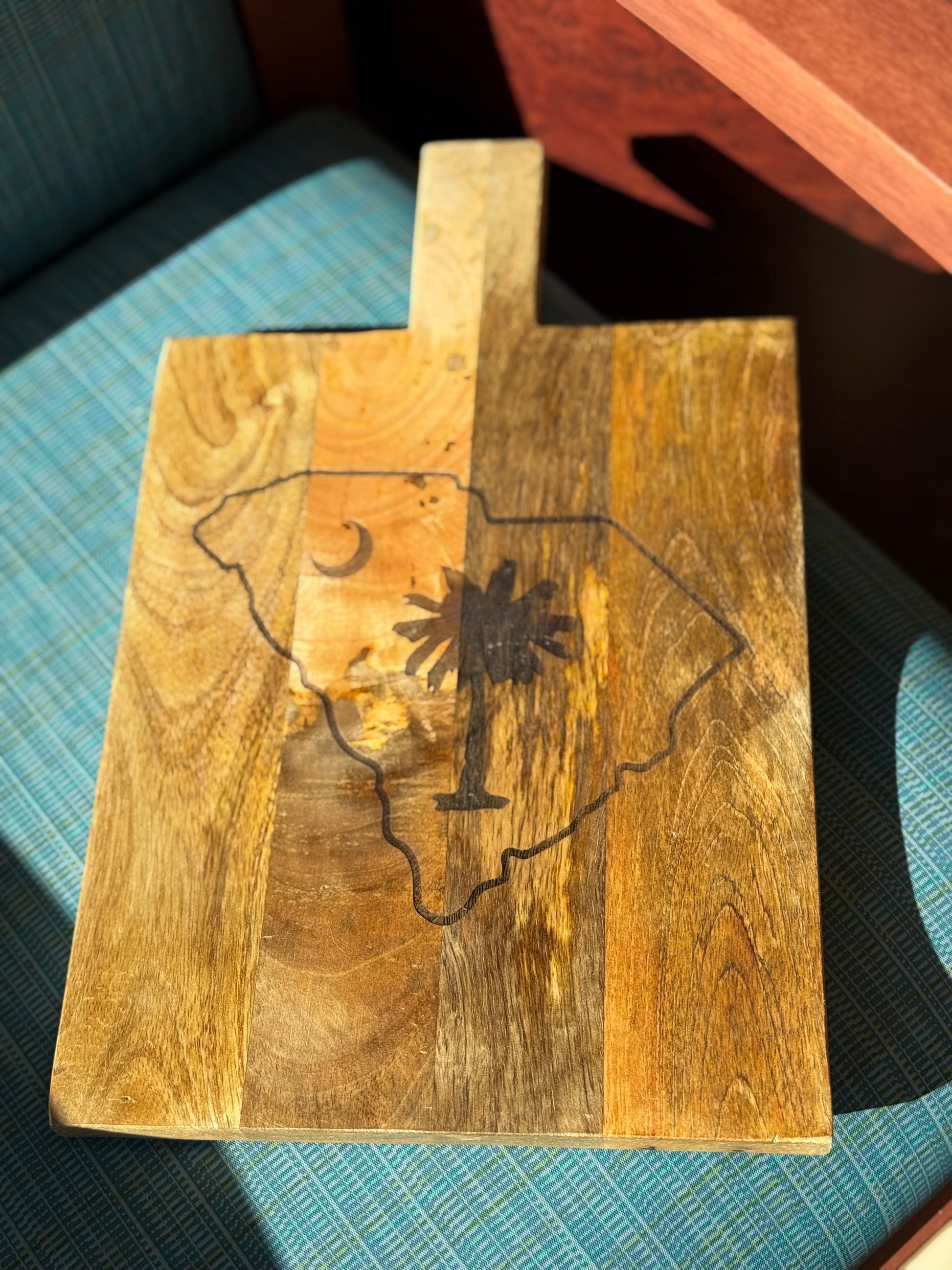 Personalized decorative cutting board with the state of south carolina with palmetto tree inside state