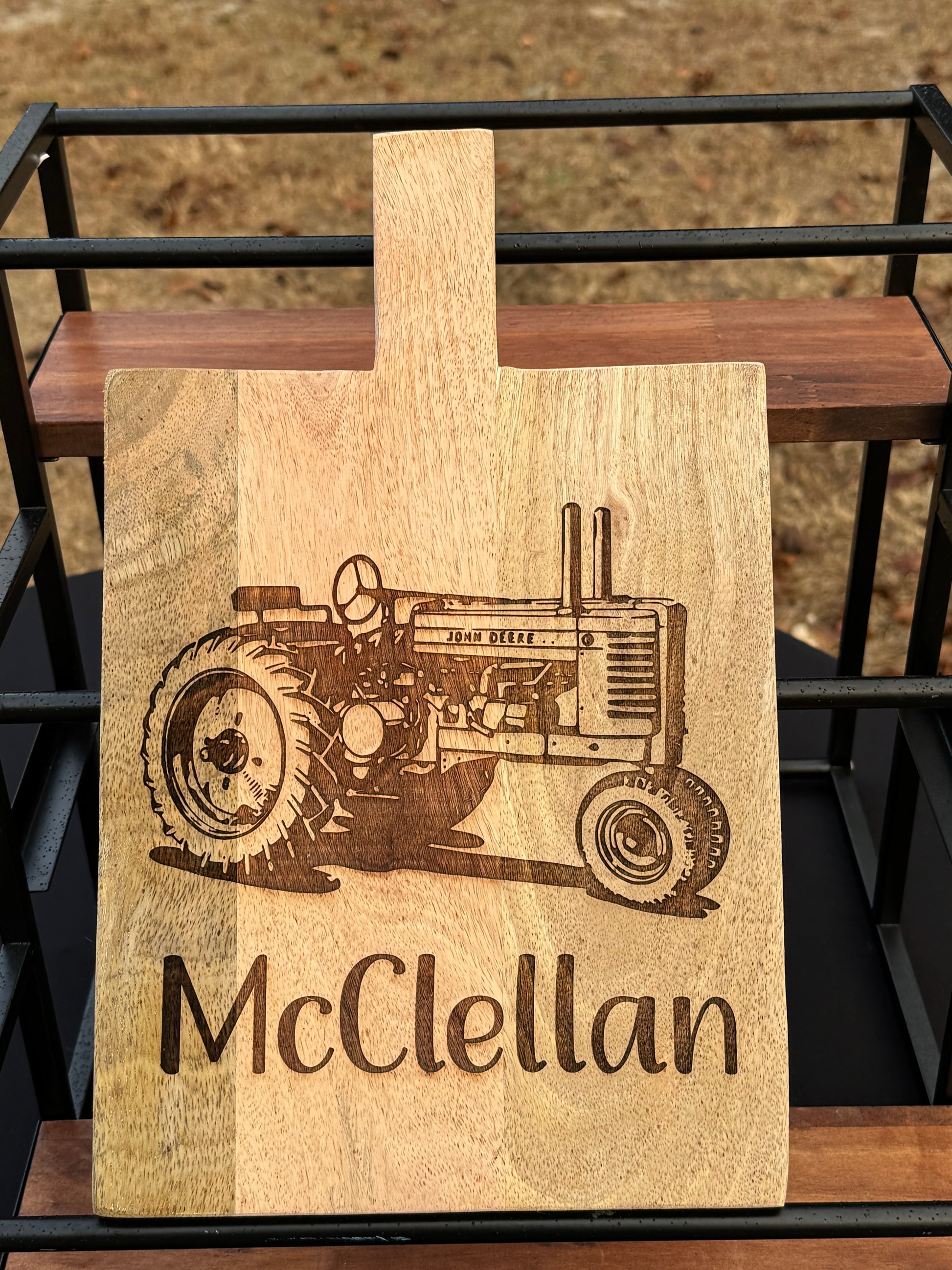 Persoanlized decorative cutting board with john deer tractor and family name under