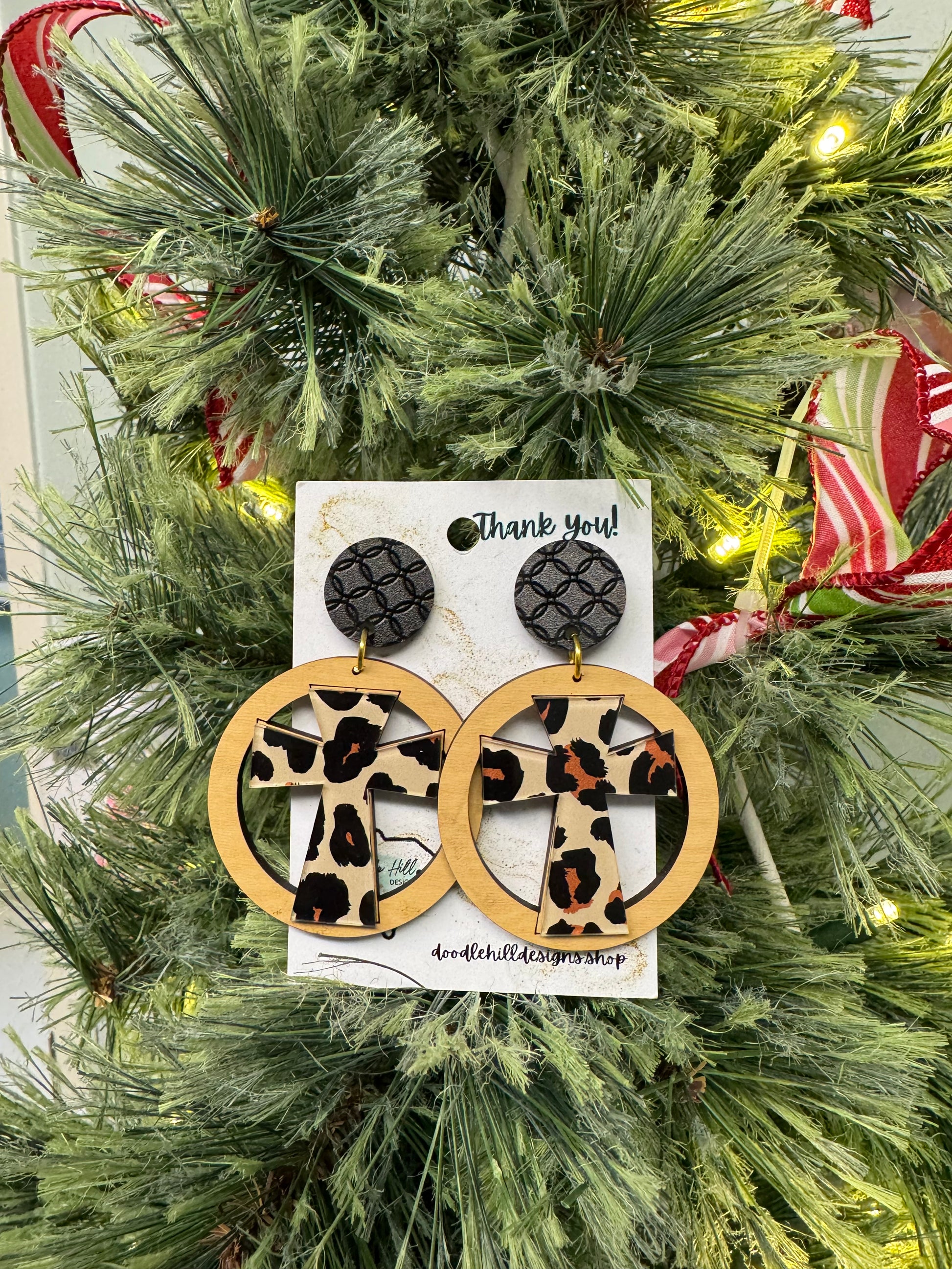 leopard cross earrings with birch circle around. Black textured post 