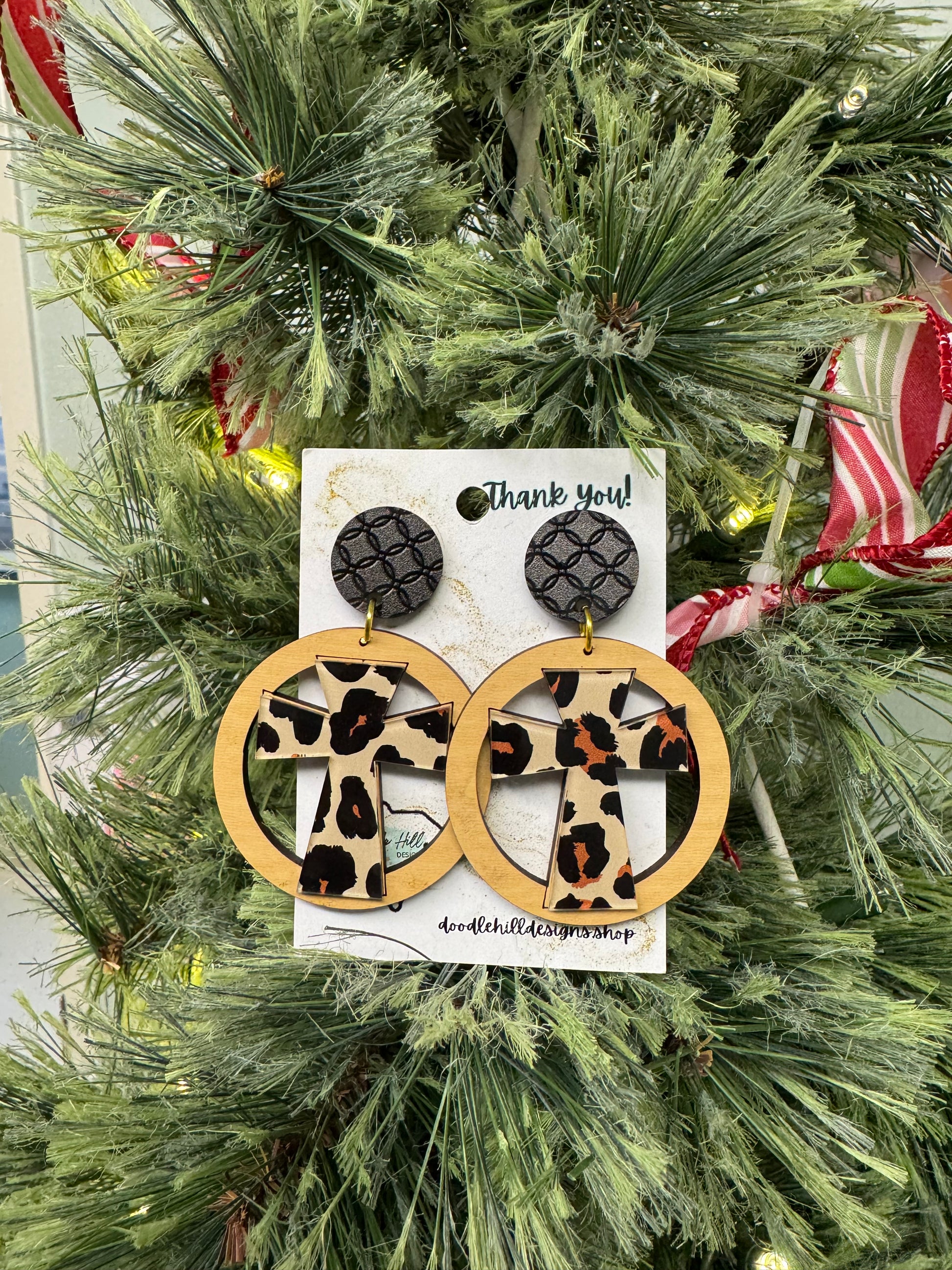 leopard cross earrings with birch circle around. Black textured post 