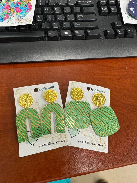 rainbow shapped and square  shapped gold mirror earrings with a green zebra print. Post are gold textured