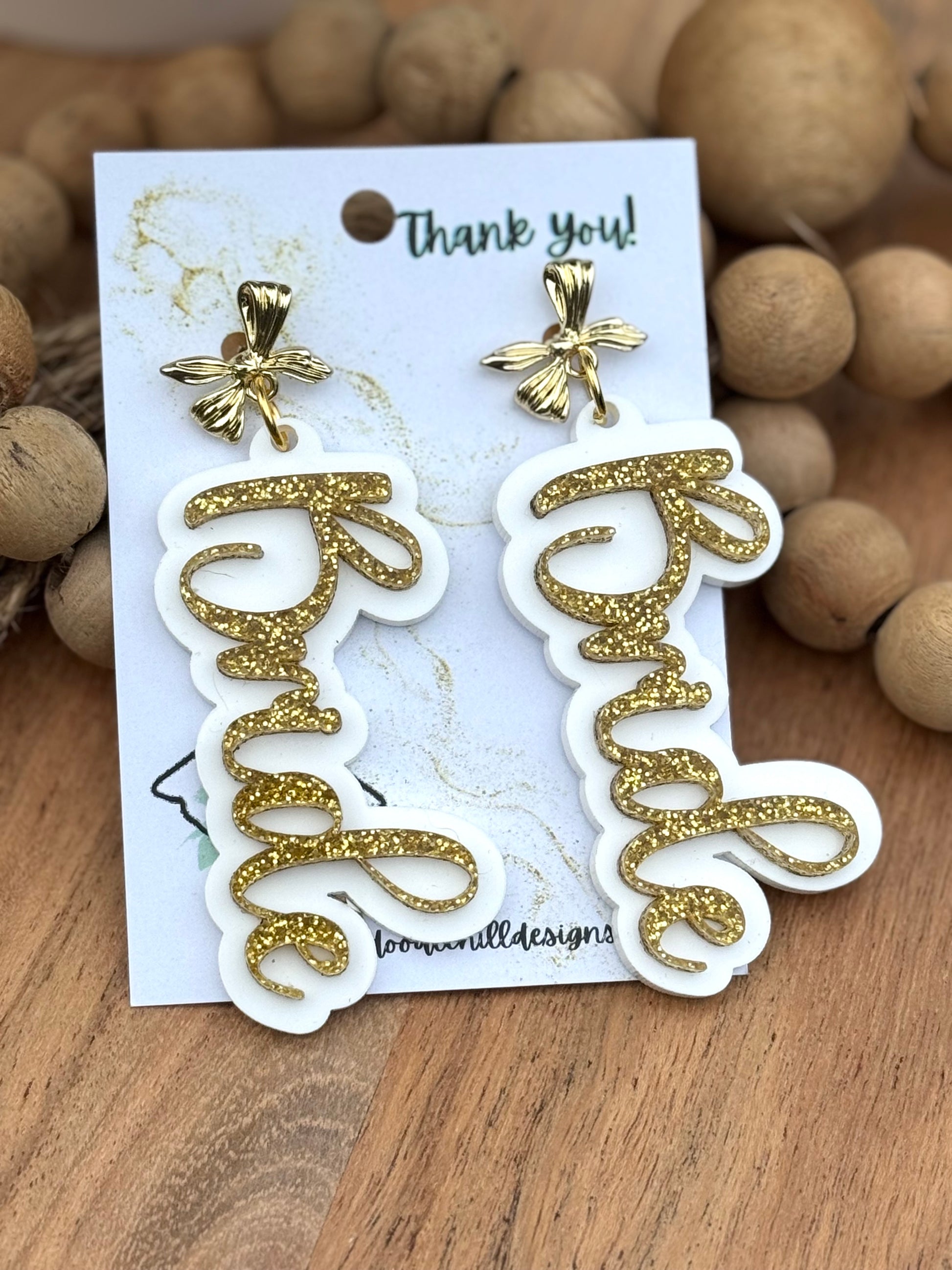 "Bride earrings for bachelorette party – lightweight white acrylic with gold glitter script. Bridal shower jewelry with gold floral posts, perfect wedding gift for bride-to-be. Trendy statement earrings for casual or formal bridal events."
bride earrings, bachelorette party, bridal shower jewelry, wedding gift, statement earrings, gold glitter script